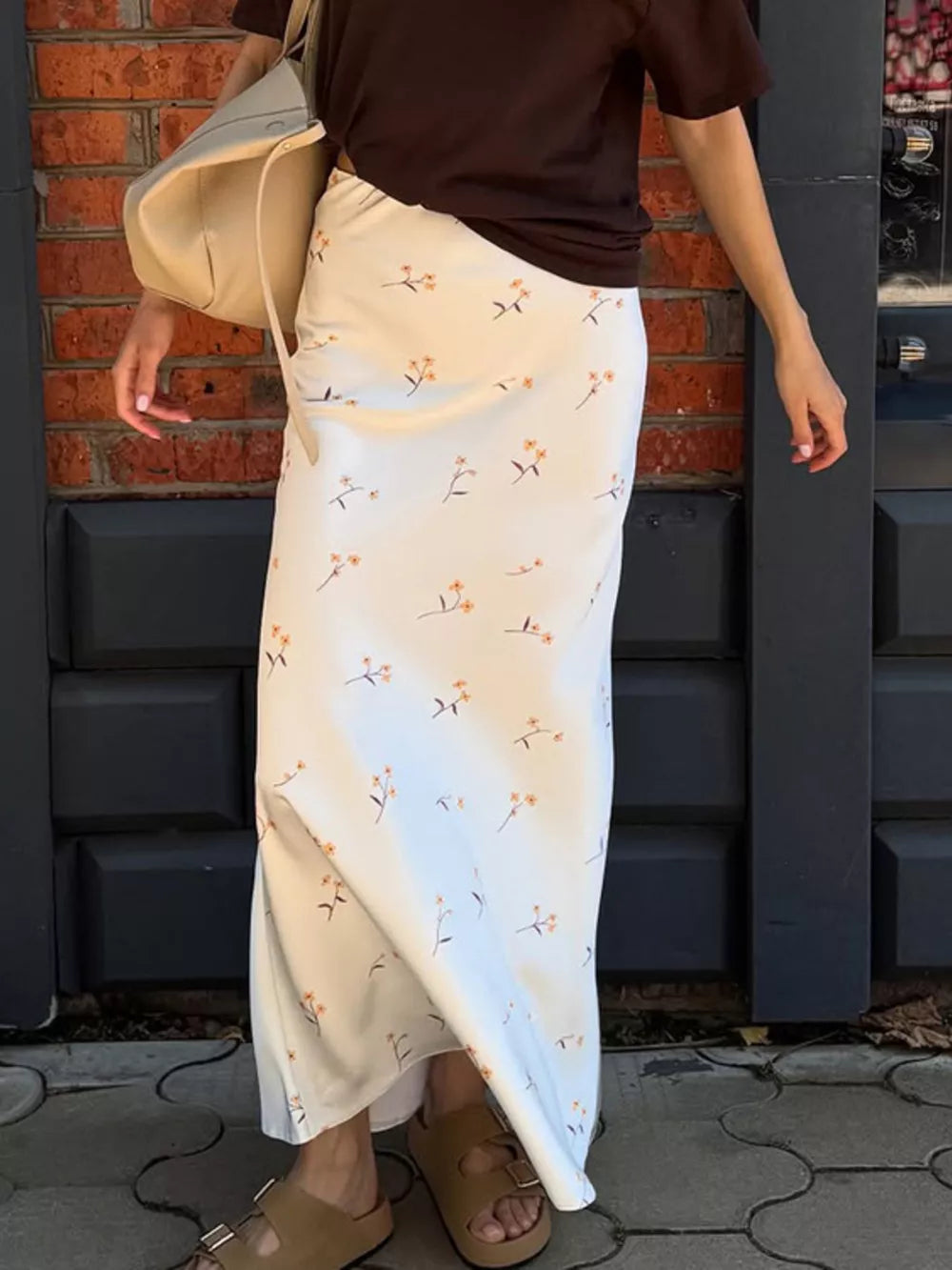 White satin midi skirt with a delicate orange floral print and a relaxed fit.