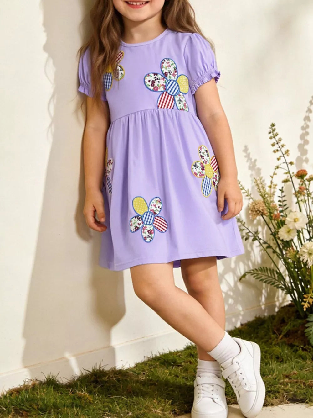 Lavender cotton toddler dress with patchwork floral appliqués and puff sleeves.