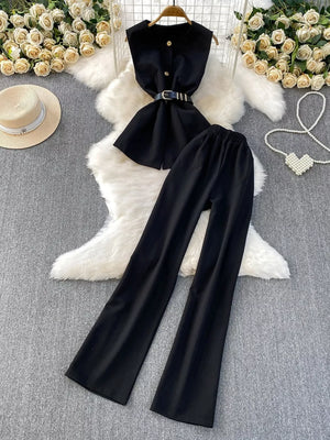 Black belted two-piece set with sleeveless top and wide-leg pants.