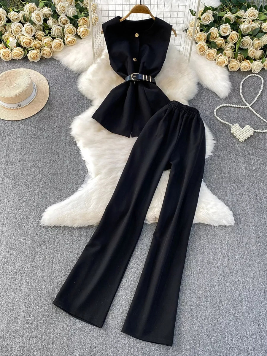 Black belted two-piece set with sleeveless top and wide-leg pants.