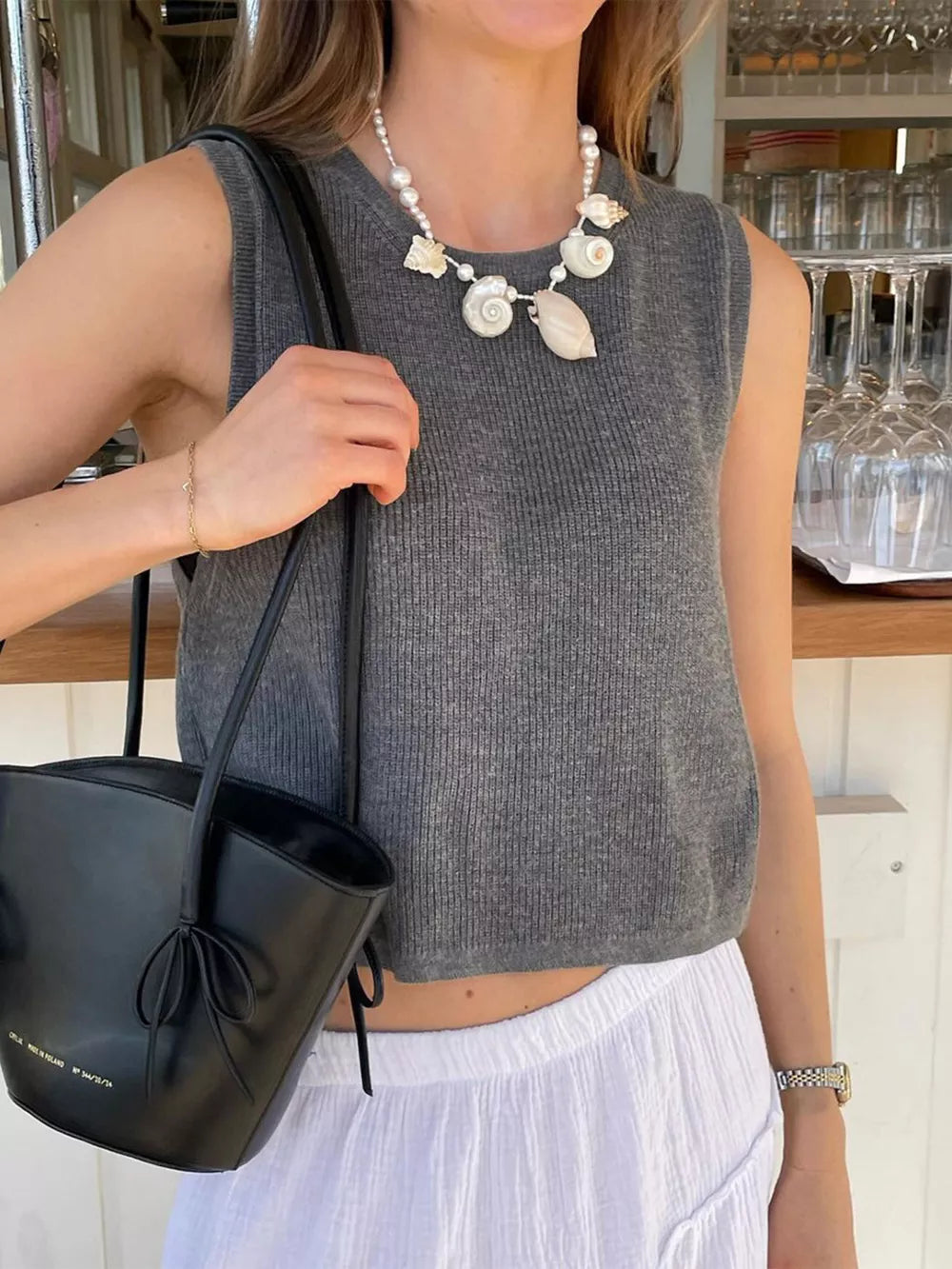 Textured grey cropped sweater vest with a ribbed knit and sleeveless design.