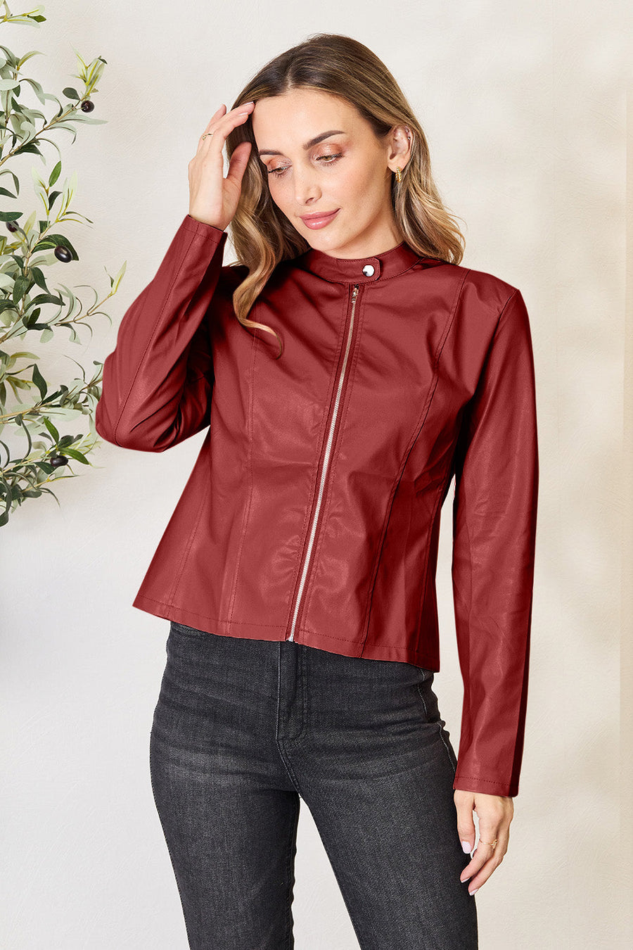 Red orange faux leather biker jacket with zip front and mock neck.