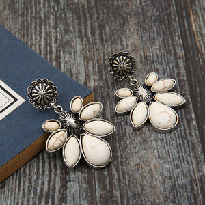 White petal drop earrings with silver floral accents and stone details.