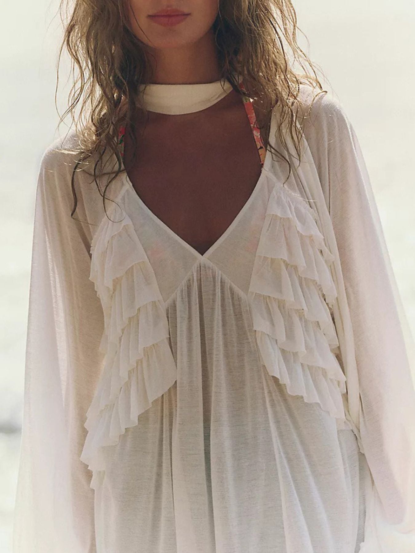 White sheer ruffle trim beach cover-up with deep V-neck and long sleeves.