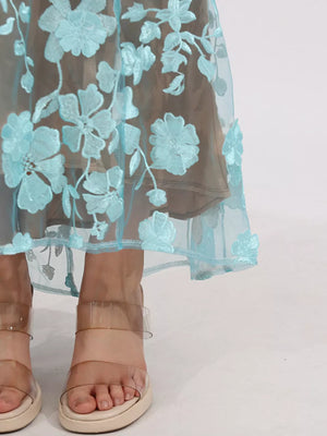 Sheer blue floral embroidered midi skirt with a beige lining.