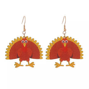 Festive turkey dangle earrings in acrylic with gold accents.