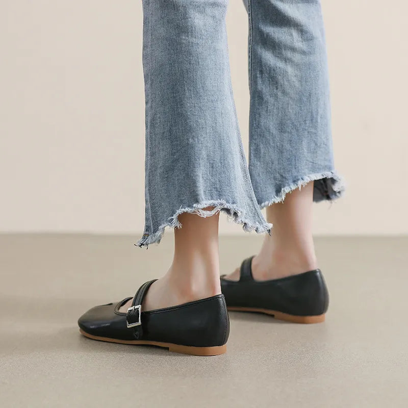 Black Tabi Mary Jane flats with a single strap and buckle, styled with cropped frayed jeans.
