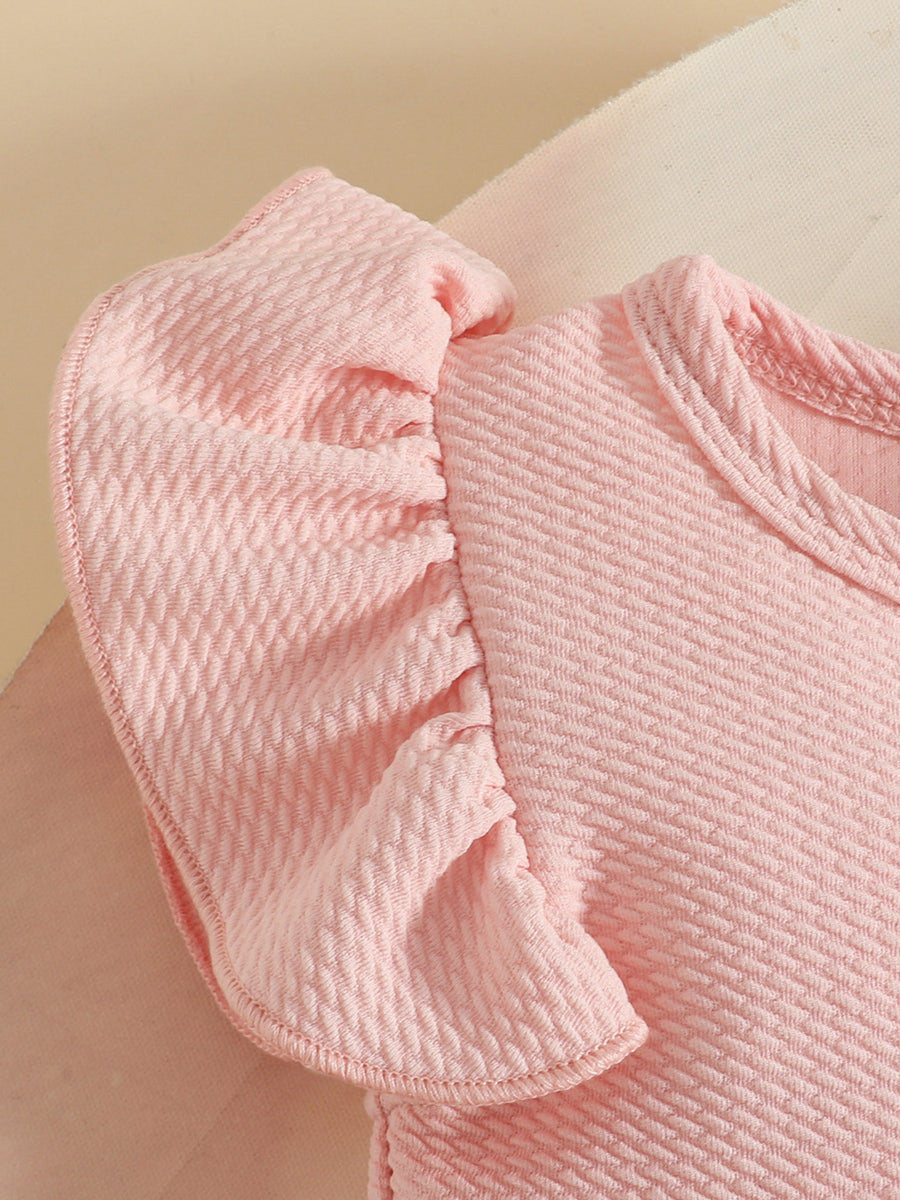 Pink baby dress with textured fabric and ruffled sleeves