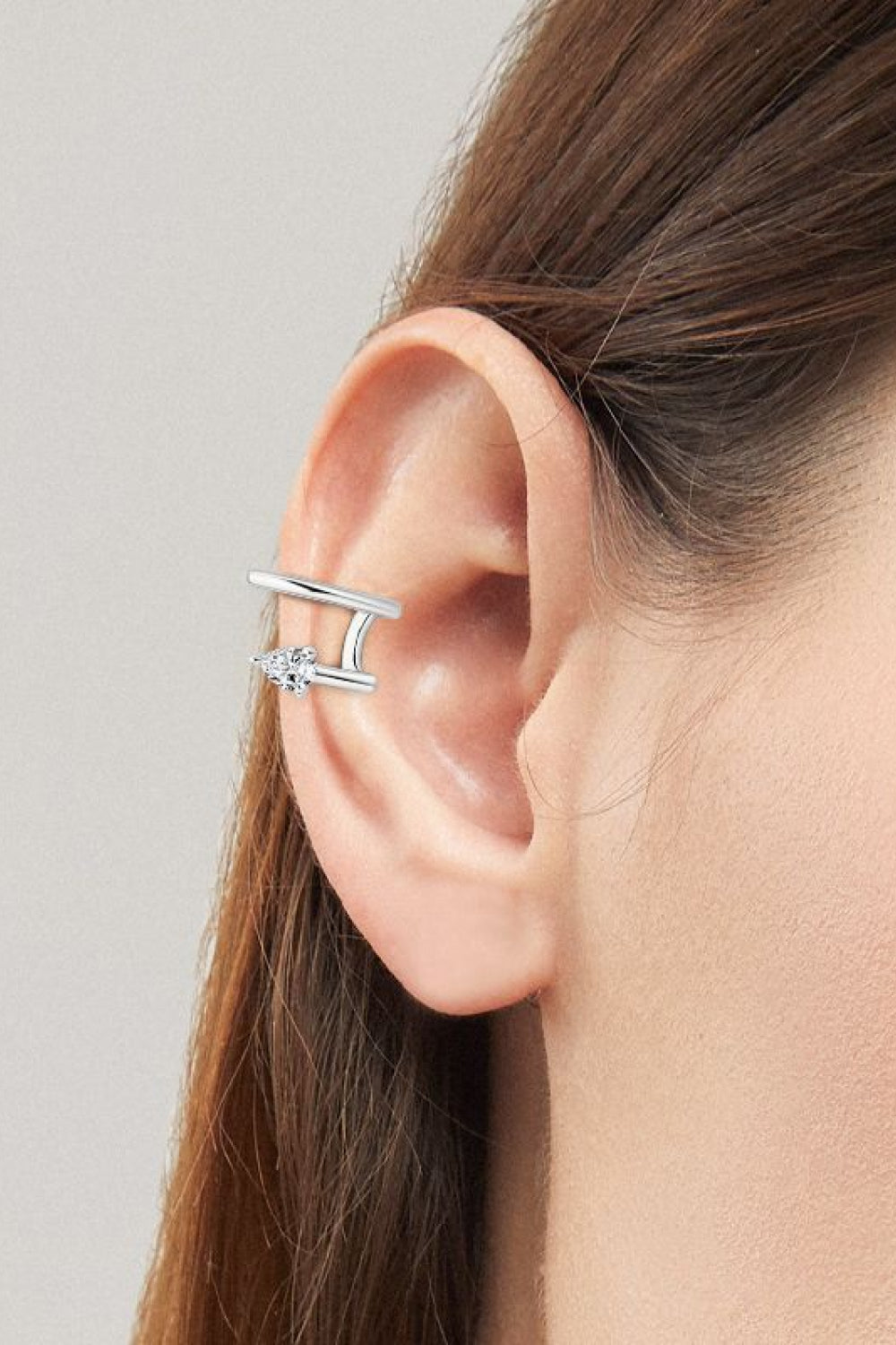 Silver spiral diamond ear cuff with a double band design and clear stones.