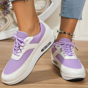 Purple and white lace-up wedge sneakers with breathable mesh panels and visible air cushioning.