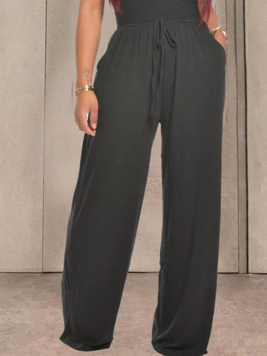Black wide-leg jumpsuit with smocked bodice, drawstring waist, and pockets