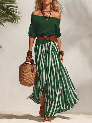 Green off-shoulder top with a striped maxi skirt and brown belt.