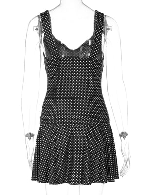 Black polka dot ruffled crop top and flared skirt set with V-neck detail.