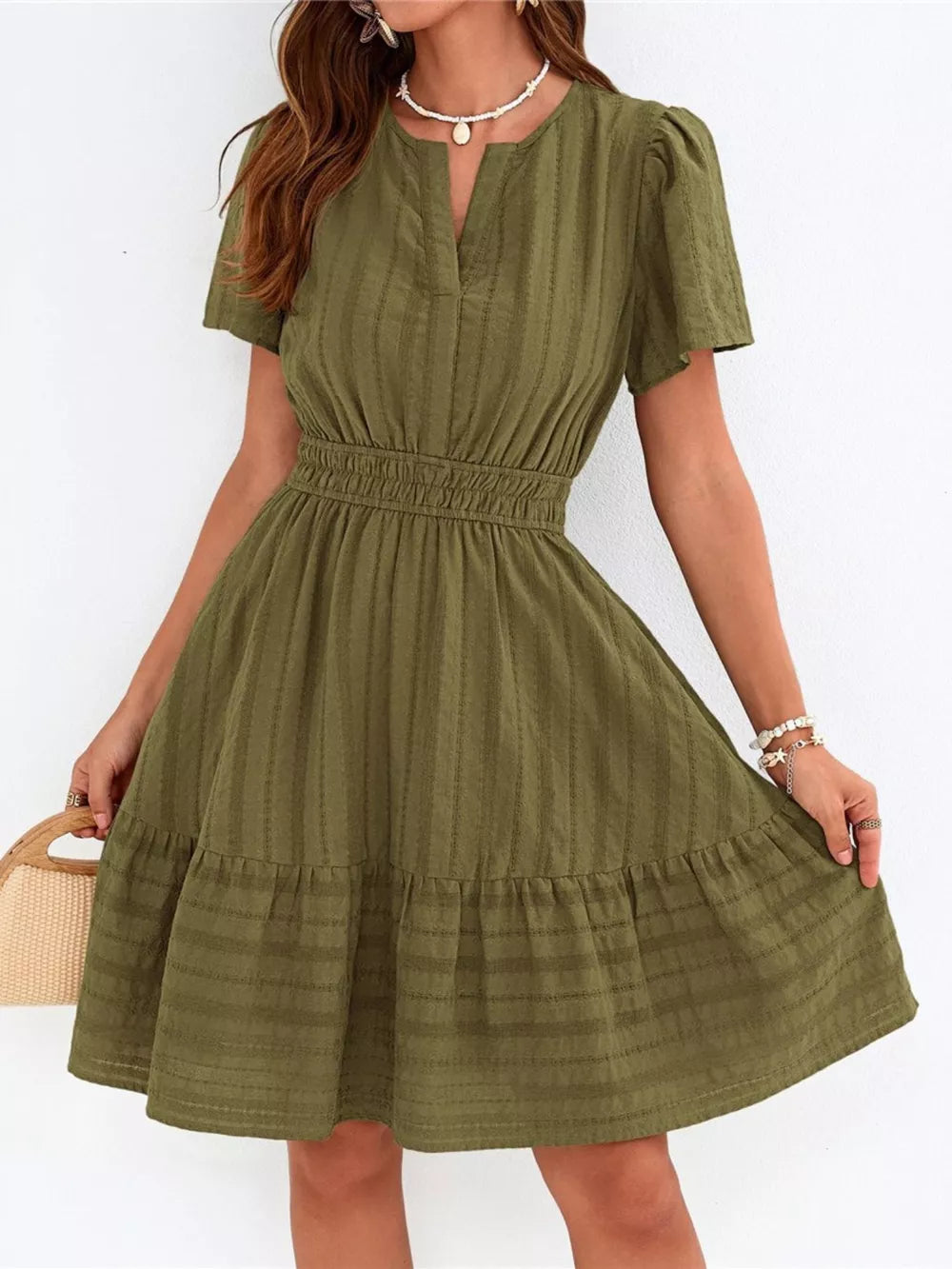 Army green textured V-neck tiered dress with smocked waist and short sleeves.