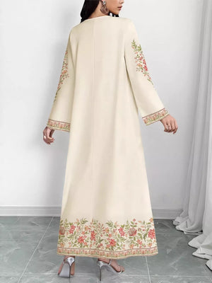 Elegant cream maxi dress with floral embroidery on sleeves and hem.