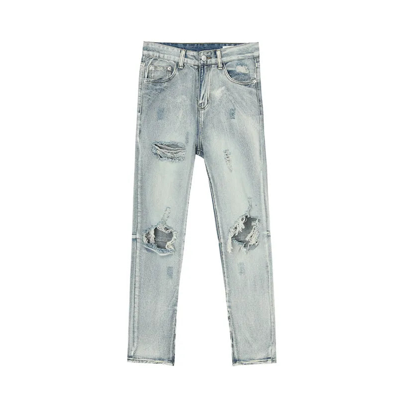 Light wash distressed skinny jeans with ankle zippers and ripped details.