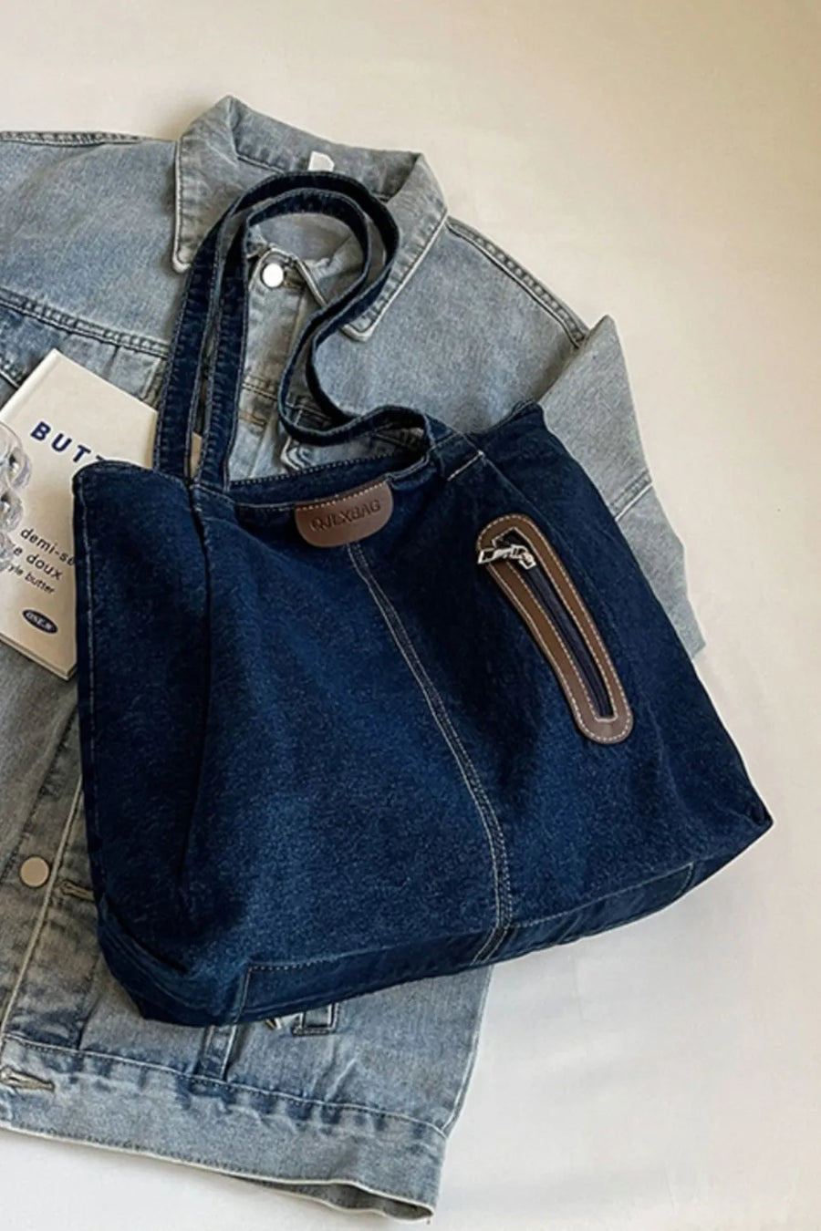 Denim tote bag with leather trim and zipper pocket detail