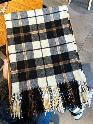 Black plaid scarf with fringe detail and a cozy feel.