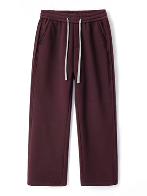 Burgundy relaxed fit men's sweatpants with white drawstring and side pockets.