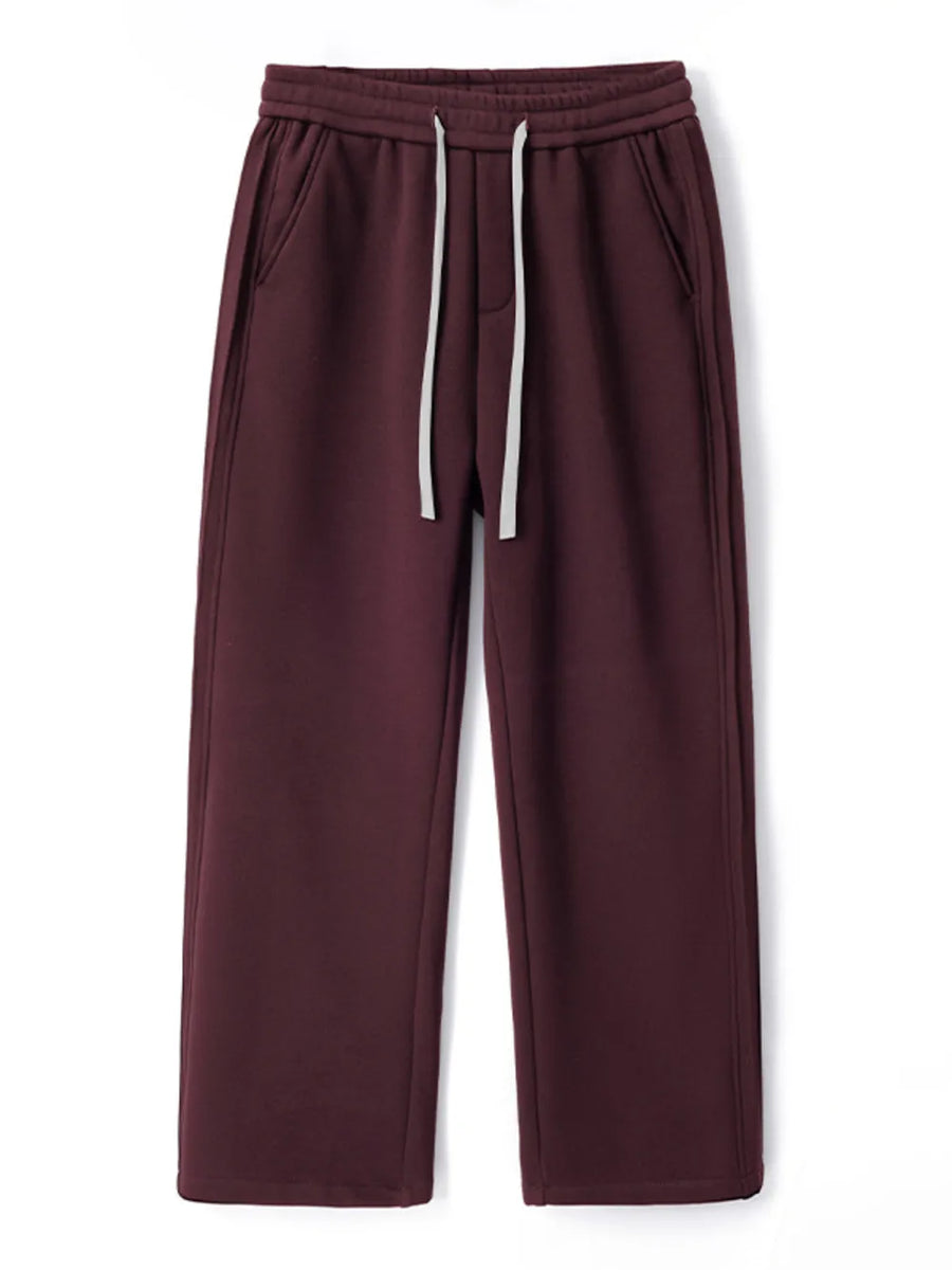 Burgundy relaxed fit men's sweatpants with white drawstring and side pockets.
