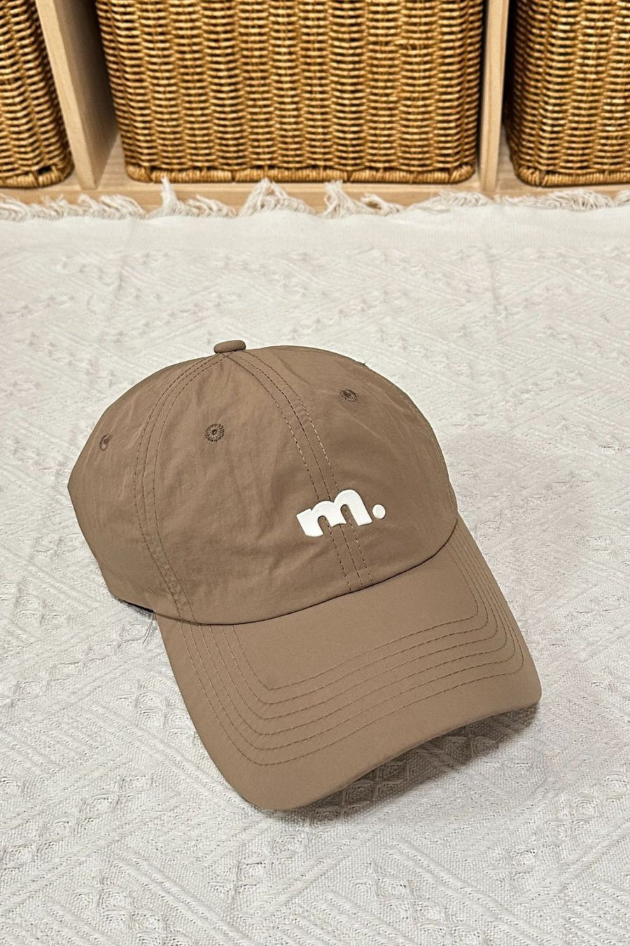 Brown baseball cap with white m. logo
