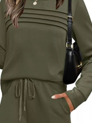 Army green casual long-sleeve top with pintuck detail and drawstring pants.