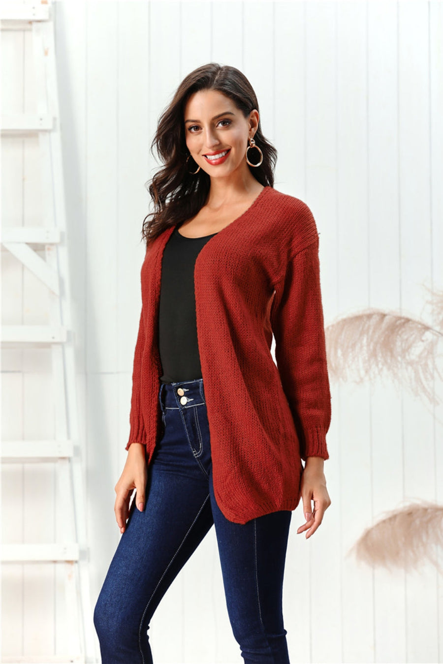 Draped knit open-front cardigan in deep red, 100% acrylic, with long sleeves and a relaxed fit.
