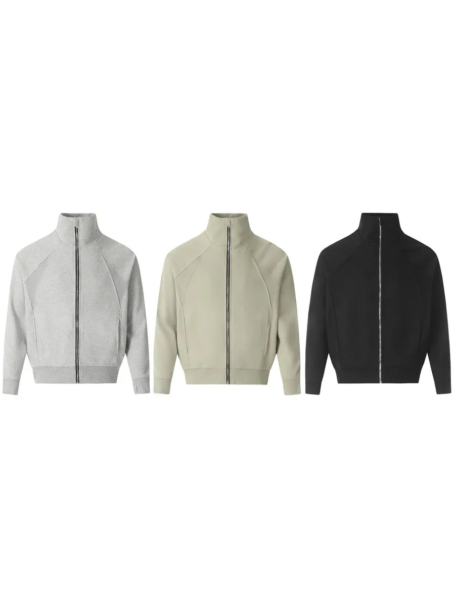 Zip-up sweatshirt in gray, sage, and black with sculpted seam details and a stand-up collar.