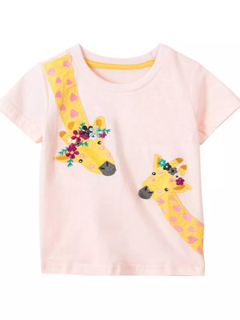 Pink cotton t-shirt with two giraffe appliques wearing floral crowns and yellow patterned necks.