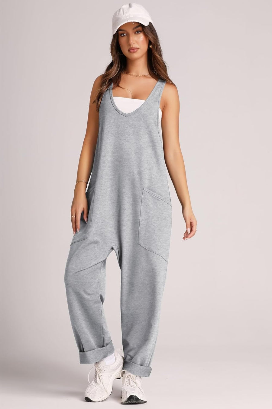 Gray relaxed fit jumpsuit with V-neck, oversized pockets, and cuffed ankles.