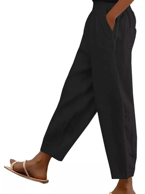 Black wide-leg maternity pants with pockets and a relaxed fit.