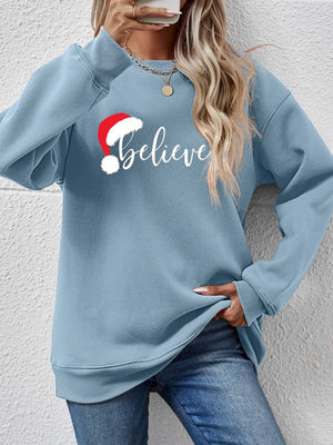 Light Blue raglan sweatshirt with "Believe" and Santa hat graphic.