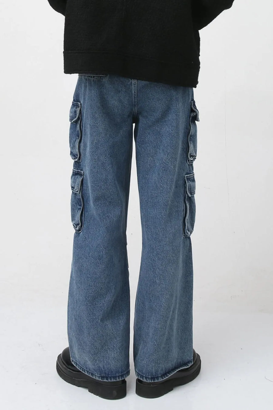 Baggy denim cargo pants in medium wash with multiple flap pockets and a relaxed fit.