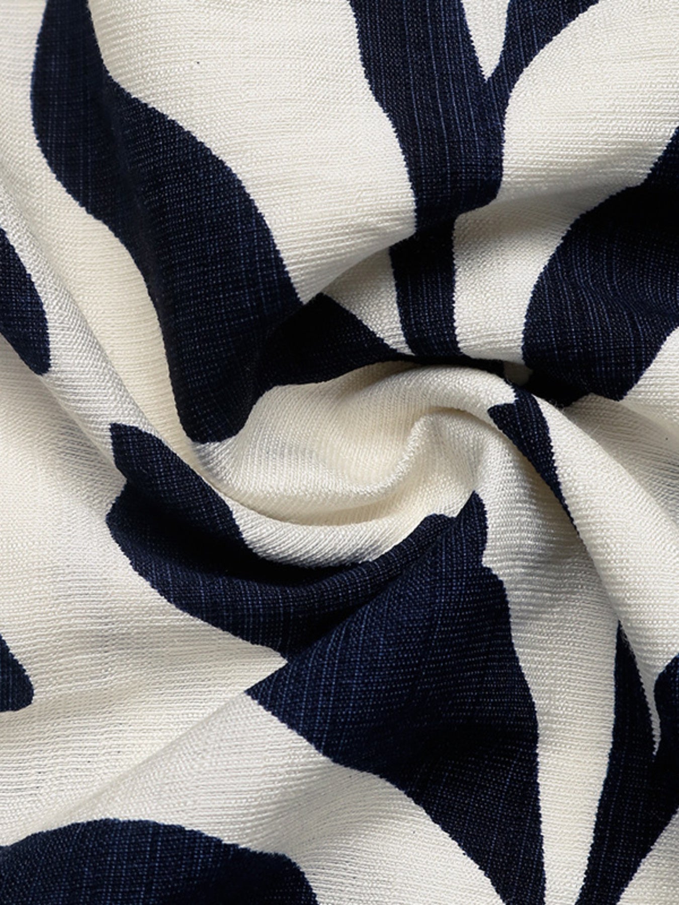 Tropical leaf print belted dress in navy and white textured fabric.