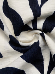 Tropical leaf print belted dress in navy and white textured fabric.
