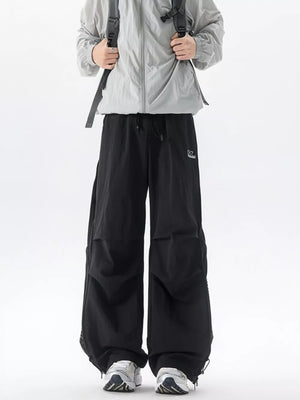 Black cargo sweatpants with adjustable waist and mesh side panels.
