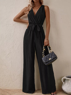 Black V-neck tie-waist wide-leg romper with sleeveless design and textured fabric.