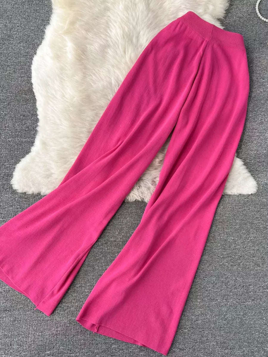 Tied waist wide leg pants in bright pink knit fabric.