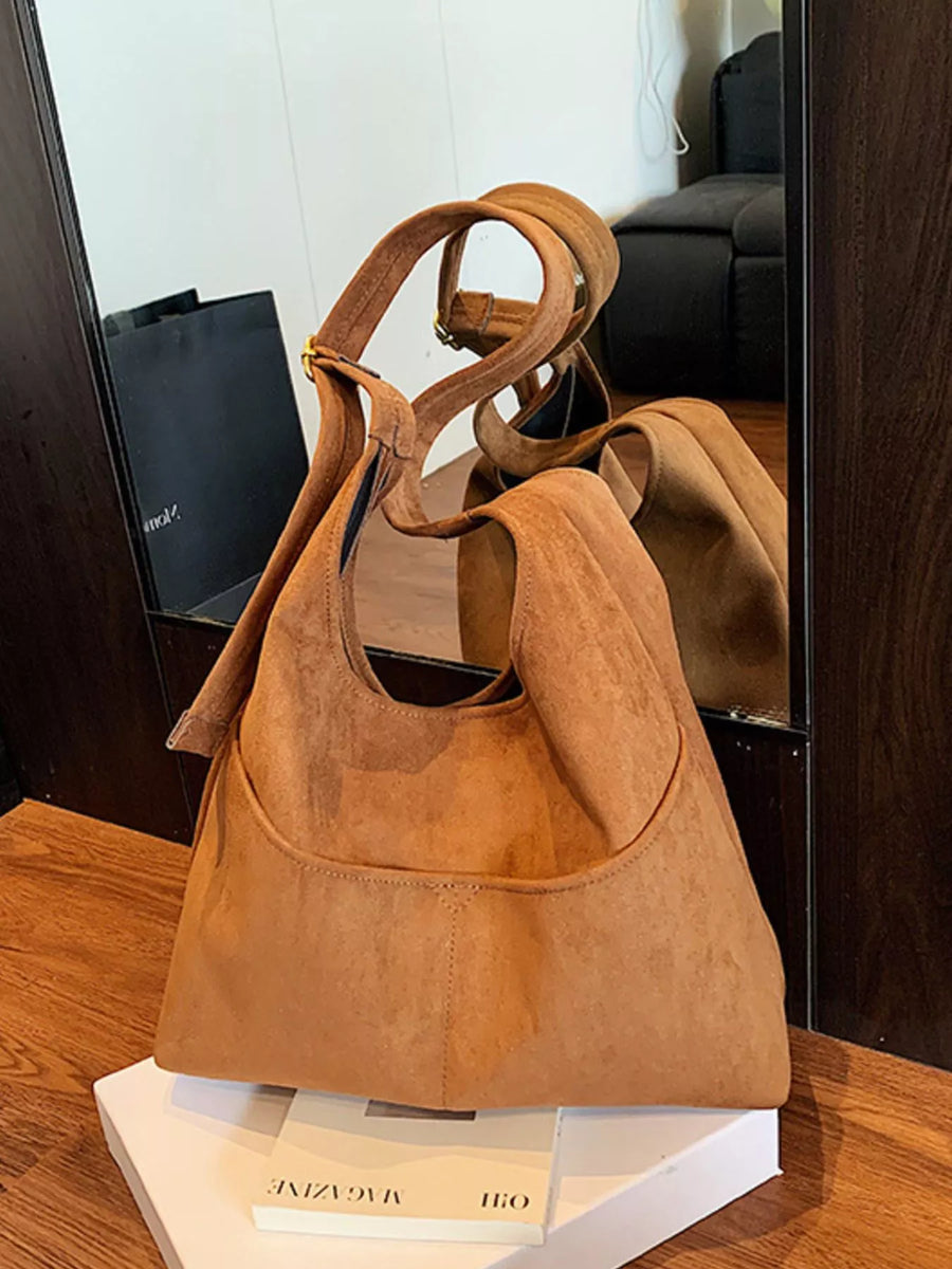 Large brown suede shoulder bag with adjustable strap and front pocket.
