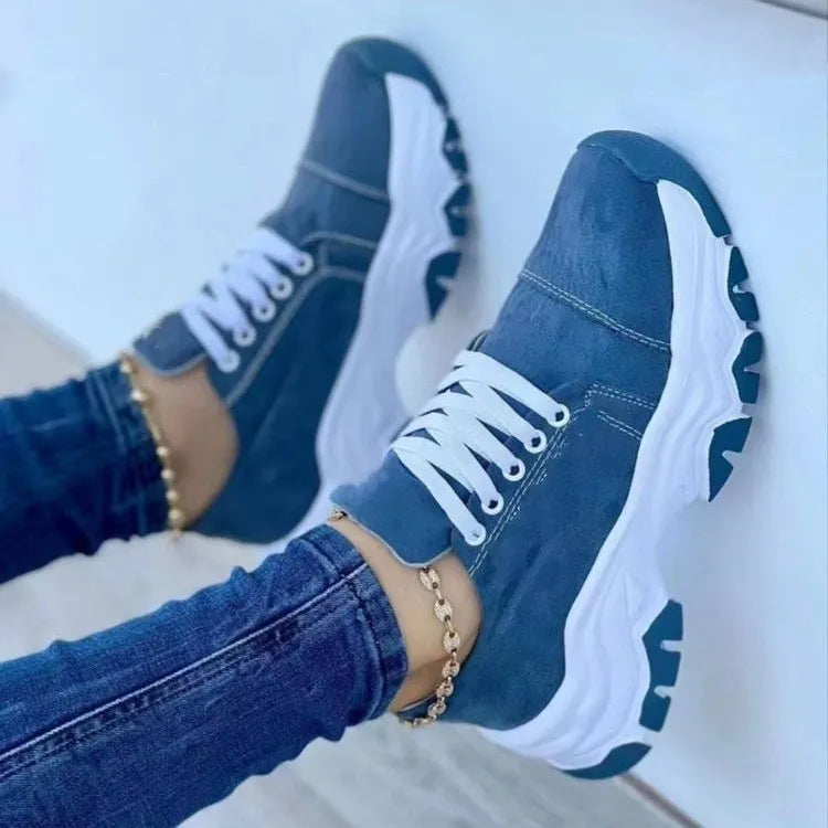 Blue denim lace-up sneakers with white chunky soles.