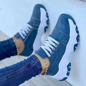 Blue denim lace-up sneakers with white chunky soles.