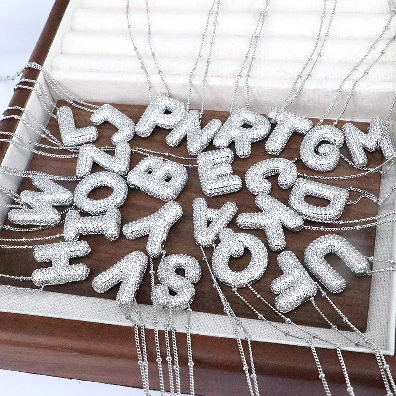 Pave initial pendant necklaces with beaded chains in silver tone, featuring various alphabet letters.