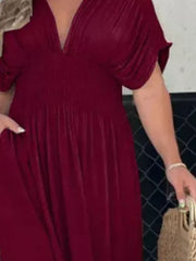 Burgundy V-neck maxi dress with smocked waist and dolman sleeves.