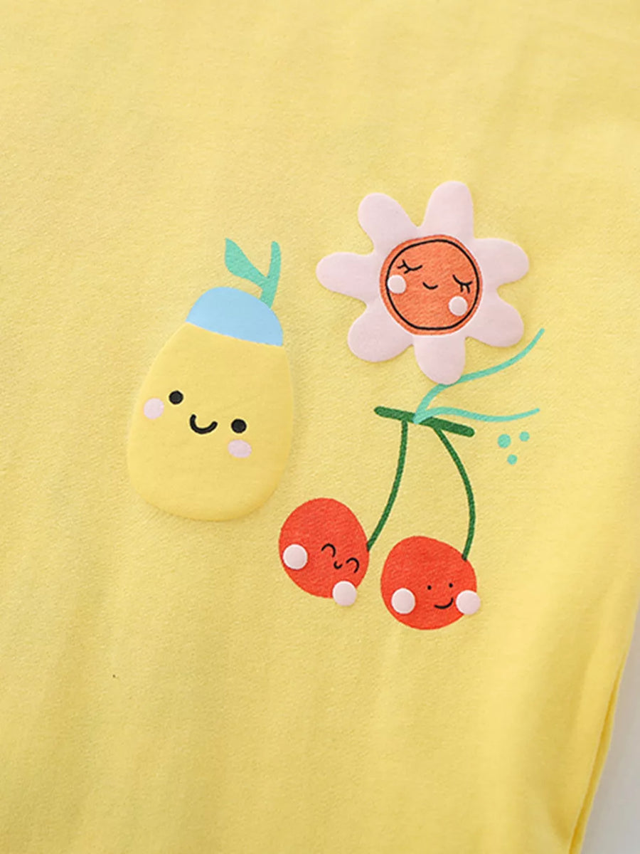 Yellow baby tee with playful fruit and flower applique details.