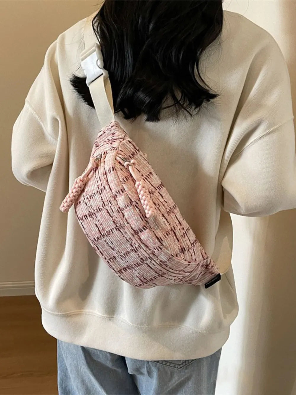 Pink tweed belt bag with braided pulls and white strap