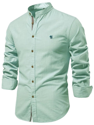 Light blue linen shirt with mandarin collar, button front, and embroidered detail.