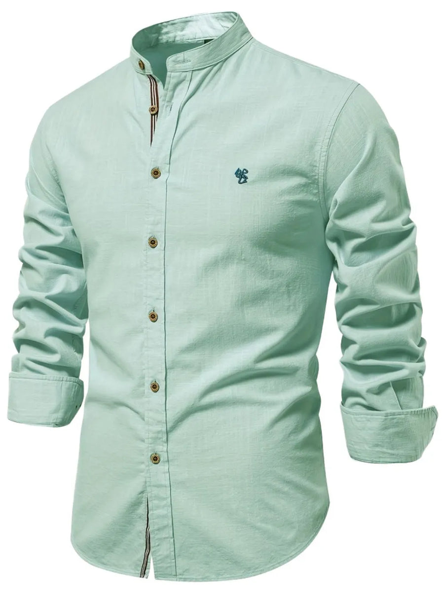 Light blue linen shirt with mandarin collar, button front, and embroidered detail.