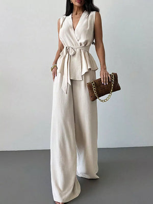 Sleeveless wrap top with belted peplum and wide-leg pants set in cream polyester.