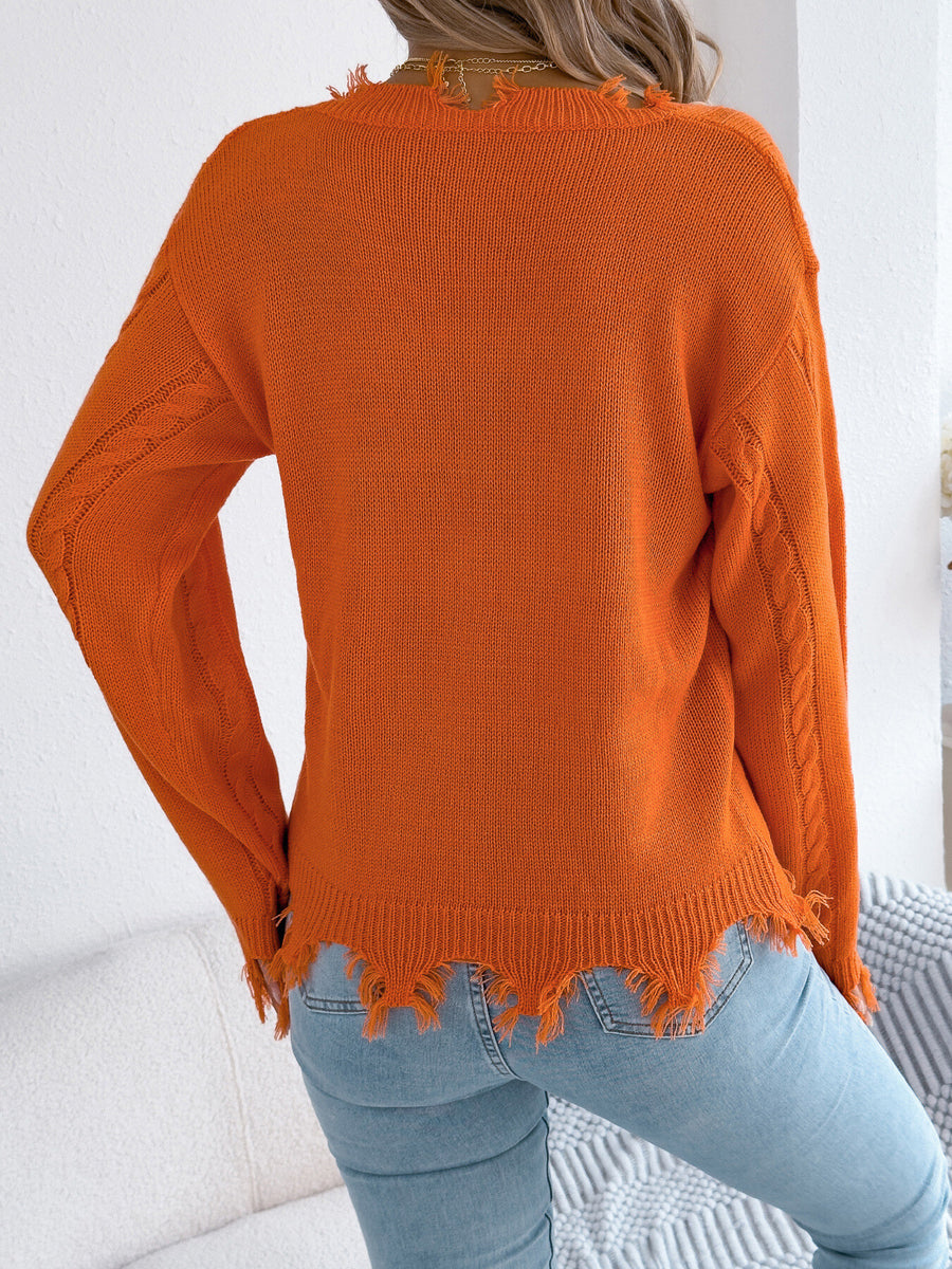 Orange v-neck sweater featuring distressed and cable knit