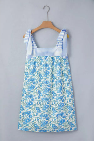 Botanical print mini dress with tie straps and blue stripe bodice detail.